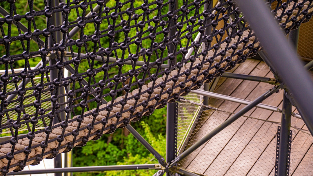 services-img a-close-up-view-of-a-rope-bridge-with-wooden-planks-2f1fz6q1-vi